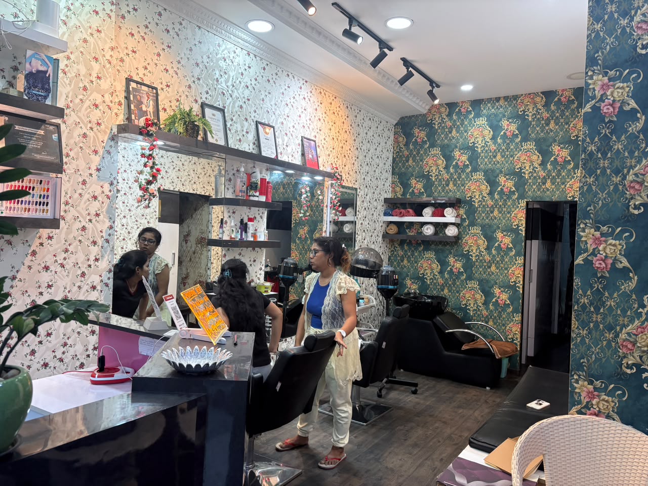 Sparkle Unisex Salon main floor in action with stylists, styling stations, and mirrors
