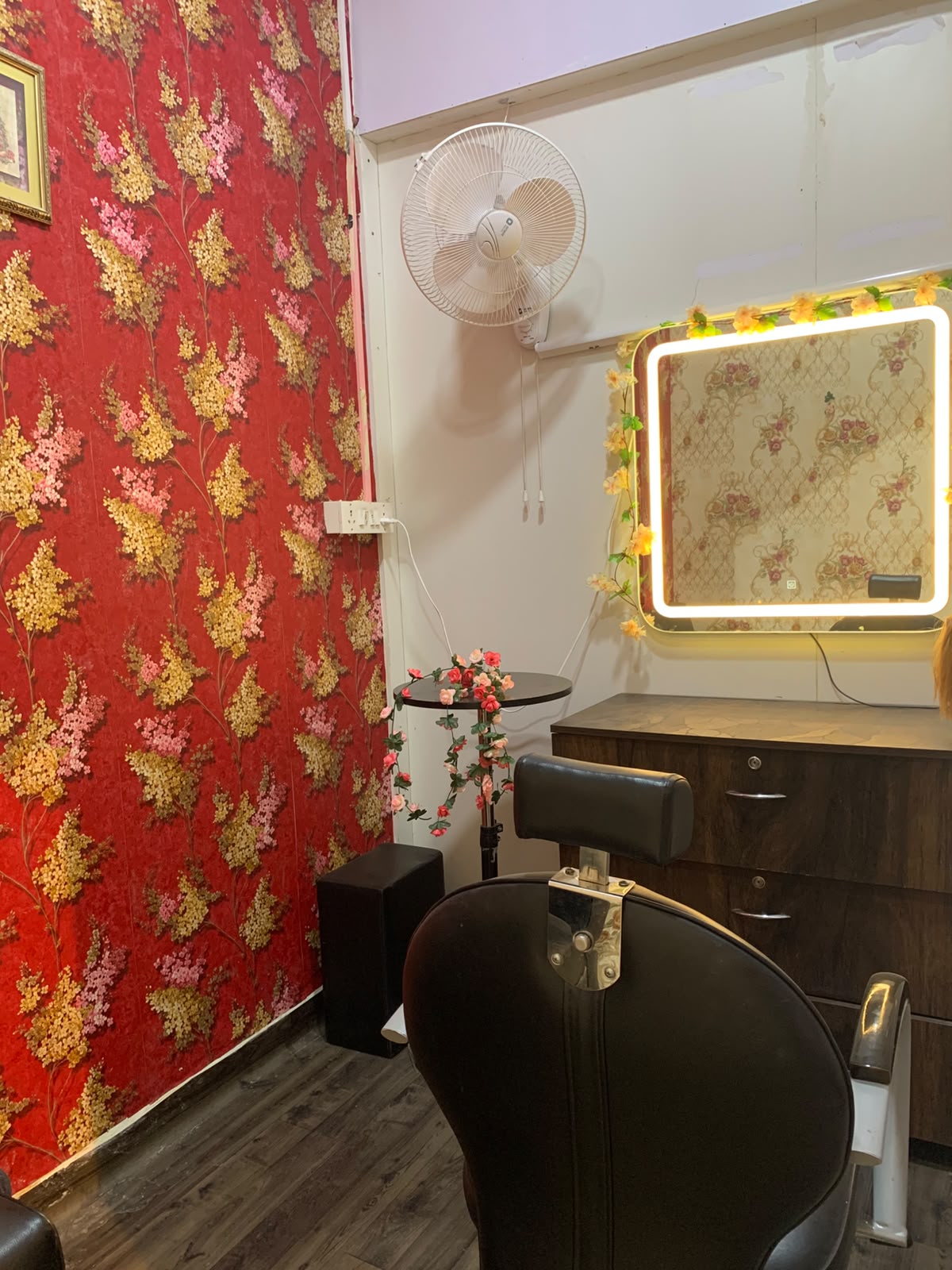 Illuminated LED vanity mirror and professional styling chair at Sparkle Studio